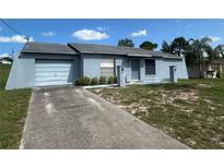 Charming single-story home with an attached garage and well-lit walkway at 5391 Pillar Ave, Spring Hill, FL 34608