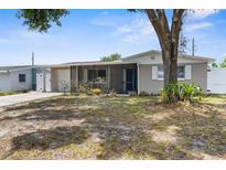 Charming single-story home features a covered front porch, well-maintained landscaping, and a classic design at 6633 Jackson St, New Port Richey, FL 34653