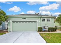 Charming single-story home with a manicured lawn and attached two-car garage at 8149 Ambersweet Pl, Land O Lakes, FL 34637