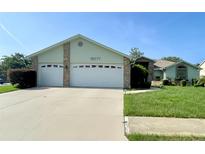 Charming single-story home featuring a two-car garage and a well-manicured lawn at 10277 Rosetti Ct, Spring Hill, FL 34608