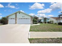 Charming single-story home features a well-maintained lawn, two-car garage, and inviting front entrance at 10277 Rosetti Ct, Spring Hill, FL 34608