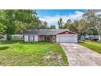 Charming single-story home featuring a well-maintained lawn and an attached two-car garage at 11340 Corinthian St, Spring Hill, FL 34609