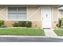 Charming single-story home with a well-maintained lawn, stone accents, and a welcoming white front door at 11715 Boynton Ln # 74B, New Port Richey, FL 34654