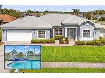 Charming home featuring a grey exterior, well-maintained lawn, and a delightful screened-in pool with a water feature at 13627 Lightning Rod Ct, Hudson, FL 34669