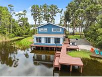 Charming waterfront home with a private dock and beautiful lake views, perfect for relaxing and enjoying nature at 1602 Beachway Ln, Odessa, FL 33556