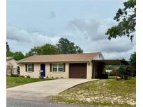 Charming single-story home featuring a well-maintained yard, covered parking and a freshly painted exterior at 2234 Marietta Ave, Spring Hill, FL 34608