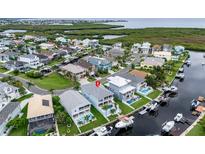 Waterfront home featuring a private pool and boat dock for easy access to the bay at 6140 Seaside Dr, New Port Richey, FL 34652