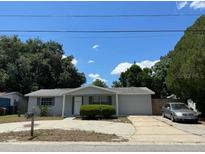 Charming single-story home featuring a well-maintained lawn and mature trees at 7222 Coventry Dr, Port Richey, FL 34668