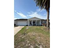 Charming single-story home featuring a lush front yard and a welcoming covered front porch at 7540 Briarwood Dr, Port Richey, FL 34668