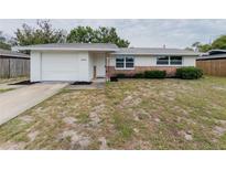 Charming single-story home with brick accents, updated windows, and a one car garage at 7608 Bougenville Dr, Port Richey, FL 34668