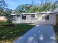 Charming single-story home with a well-maintained lawn and newly painted driveway at 9432 84Th St, Seminole, FL 33777