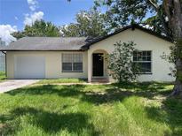 Charming single-story home featuring a one-car garage, well-maintained lawn, and inviting front entrance at 3326 Vorden St, New Port Richey, FL 34655