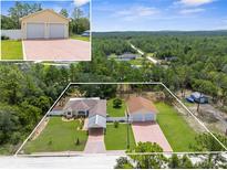 Expansive property featuring a well-maintained home, detached garage, and generous lot with mature trees, perfect for outdoor enjoyment at 13444 English Parrot Rd, Brooksville, FL 34614