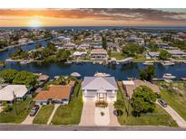 Stunning aerial view of waterfront homes, docks and boat lifts on canals at sunset in Hernando Beach at 4469 Bahama Dr, Hernando Beach, FL 34607