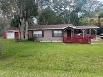 Charming single-story home with a covered carport and well-maintained front lawn at 717 Whiteway Dr, Brooksville, FL 34601