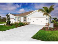 Charming single-story home with a well-manicured lawn and a spacious two-car garage at 272 Voltaire Dr, Spring Hill, FL 34609
