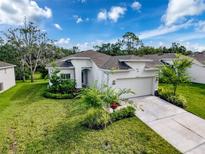 Beautiful single-story home featuring a well-manicured lawn and attractive landscaping at 4082 Watson Dr, New Port Richey, FL 34655