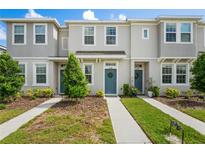 Charming townhome with neutral exterior, well-maintained landscaping, and inviting blue front door with wreath at 6240 Fairmont Ln, Palmetto, FL 34221