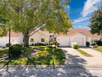 Charming villa with a well-maintained lawn and mature landscaping, offering great curb appeal at 7518 Mediterranean Ct, Hudson, FL 34667