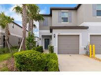 Charming townhome with a well-maintained front yard and a one car garage at 8305 Crescent Oaks Dr, New Port Richey, FL 34655