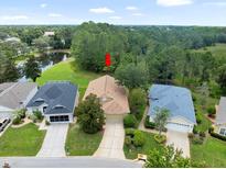 A lovely property with a scenic pond view and mature landscaping at 10097 Holly Berry Dr, Weeki Wachee, FL 34613
