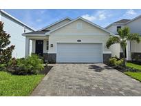 Charming single-Gathering home boasts a two-car garage and brick-paved driveway at 14429 Maiden Ter, Lakewood Ranch, FL 34211