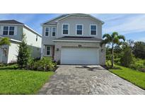 Charming two-story home with a brick-paved driveway and a two-car garage at 14441 Maiden Ter, Lakewood Ranch, FL 34211