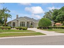 Charming single-story home featuring manicured landscaping, a spacious driveway, and a classic design at 4351 Mallard Lake Dr, Spring Hill, FL 34609