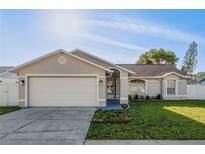 Charming single-story home featuring a well-maintained lawn and a two-car garage at 4752 Weasel Dr, New Port Richey, FL 34653