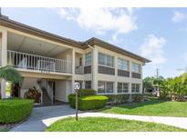 Well-maintained condo building with manicured landscaping and a convenient stairway entrance at 4754 Marine Pkwy # 103, New Port Richey, FL 34652