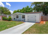 Charming single-story home with a well-maintained lawn, inviting curb appeal, and an attached garage at 6144 Glenwood Dr, New Port Richey, FL 34653