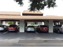 Covered parking area with assigned spaces near the building entrance, offering convenience and protection from the elements at 7614 Radcliffe Cir # B213, Port Richey, FL 34668