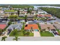 Waterfront homes with boat docks line the canals in this sunny, residential aerial view at 9921 San Mateo Way, Port Richey, FL 34668