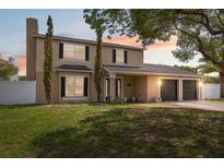 Charming two-story home with a two-car garage, a well-manicured lawn, and mature trees in a desirable neighborhood at 10091 Bannister St, Spring Hill, FL 34608