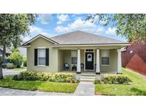 Charming home featuring a cozy front porch with stylish columns and a well-maintained lawn at 10115 Ringling St, New Port Richey, FL 34655