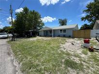 Charming single-story home featuring a well-maintained lawn, a cozy porch, and a freshly painted exterior at 11025 Harding Dr, Port Richey, FL 34668
