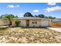 Charming single-story home featuring an attached garage, and a well-maintained front yard at 11524 Meadow Dr, Port Richey, FL 34668