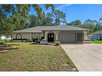 Charming single-story home features a well-manicured lawn and a two-car garage at 2152 Danforth Rd, Spring Hill, FL 34608