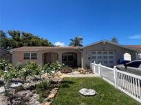 Charming single-story home with landscaped front yard and white picket fence at 3238 Coldwell Dr, Holiday, FL 34691