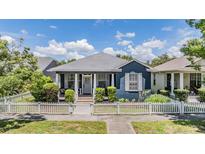 Charming blue home features a picket fence and inviting front porch at 3450 Ferrell St, New Port Richey, FL 34655