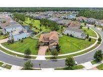 Stunning aerial view of a home on a cul-de-sac, showcasing lush landscaping and proximity to neighborhood amenities at 4026 Bonfire Dr, Odessa, FL 33556