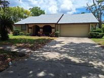 Charming single-story home with a two-car garage, manicured lawn, and inviting curb appeal at 4420 Sawgrass Blvd, New Port Richey, FL 34653