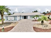 Charming single story home with beautiful landscaping, brick paver driveway and front yard palm trees at 5339 Bowline Bnd, New Port Richey, FL 34652
