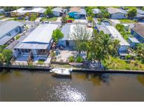 Waterfront property with boat, canal access, and views of neighboring homes in a tranquil community setting at 5824 Portsmouth Dr, Tampa, FL 33615