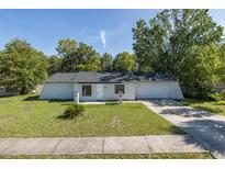 Charming single-story home with a well-maintained lawn and an attached one car garage at 9195 Bay Dr, Spring Hill, FL 34608