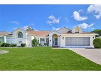 Charming single-story home with a well-manicured lawn and a two-car garage at 10285 Rosetti Ct, Spring Hill, FL 34608