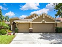 Inviting home featuring a three-car garage, manicured landscaping, and a neutral color palette at 11101 Ragsdale Ct, New Port Richey, FL 34654