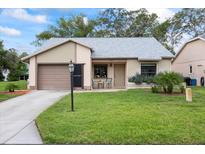 Charming single-story home with well-maintained lawn and attached garage at 11621 Pear Tree Dr, New Port Richey, FL 34654
