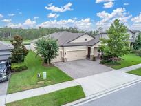 Beautiful single-story home boasting a large yard, stone accents, and a three car driveway at 11876 Ranchers Gap Dr, Odessa, FL 33556