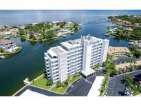 An aerial view of a white condominium building with waterfront views and a parking lot at 1365 Snell Isle Ne Blvd # 1B, St Petersburg, FL 33704